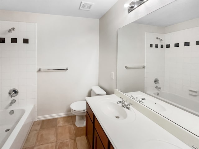 full bathroom with toilet, tile patterned flooring, vanity, and tiled shower / bath