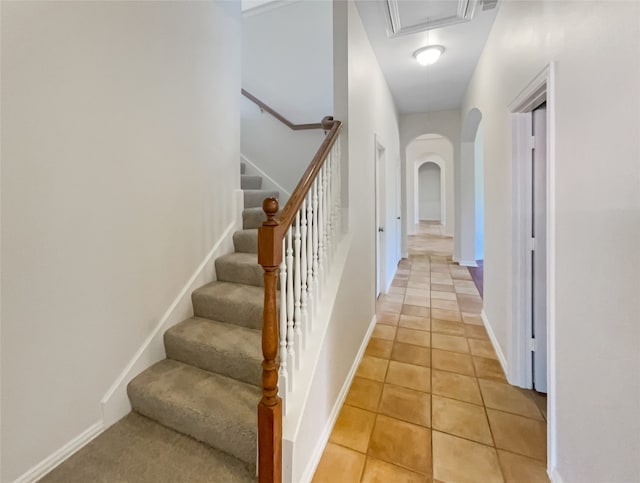 stairs featuring tile patterned floors