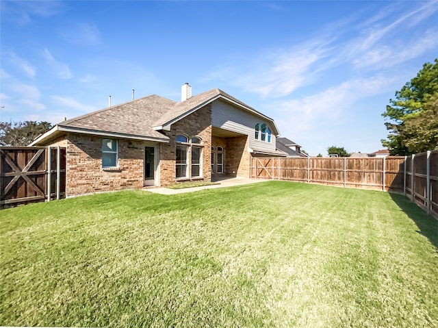 rear view of property featuring a yard