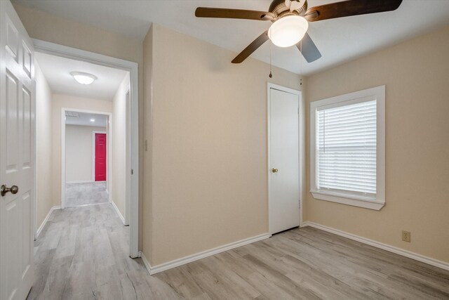 interior space with ceiling fan, a closet, and light hardwood / wood-style floors