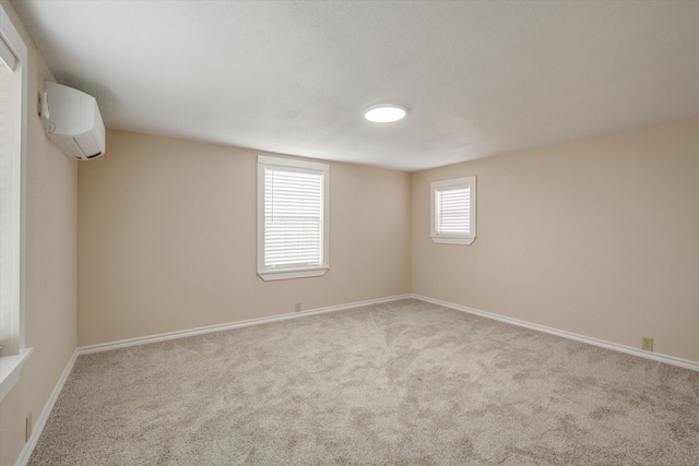 carpeted empty room with plenty of natural light and a wall unit AC