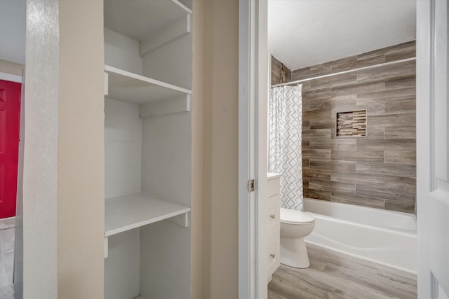 bathroom featuring hardwood / wood-style flooring, toilet, and shower / bathtub combination with curtain