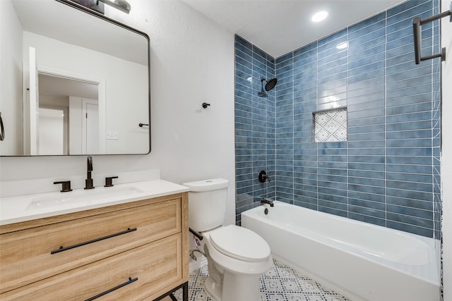 full bathroom with vanity, tiled shower / bath combo, toilet, and tile patterned flooring