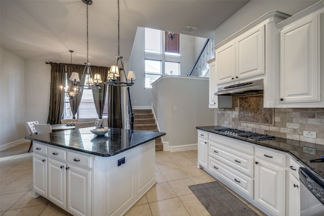 kitchen featuring light tile patterned floors, white cabinetry, backsplash, and appliances with stainless steel finishes