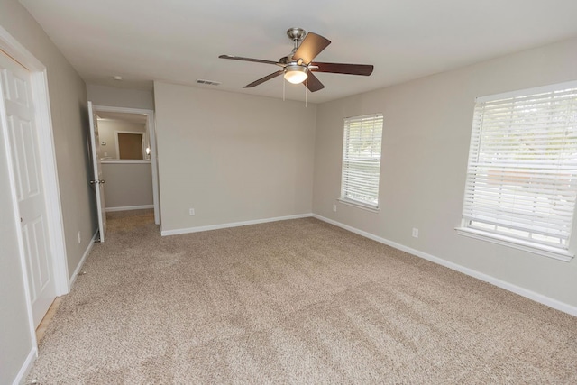 unfurnished bedroom with light colored carpet and ceiling fan