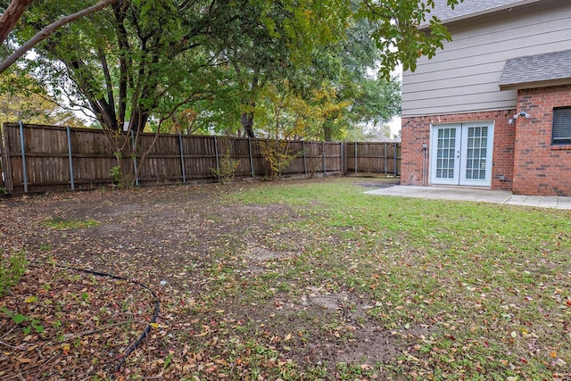 view of yard with french doors and a patio area