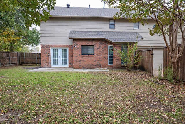 back of property featuring a lawn, a patio, and french doors