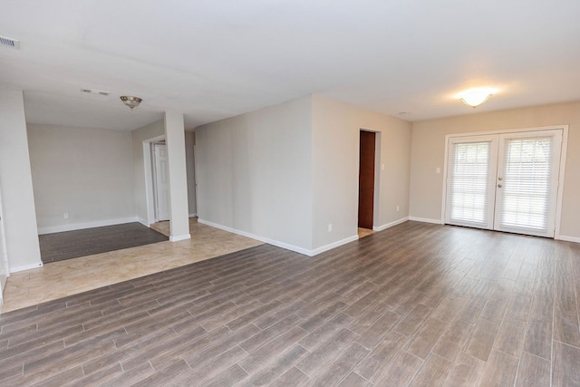 spare room with hardwood / wood-style flooring