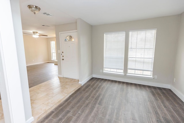 spare room with dark hardwood / wood-style floors and ceiling fan