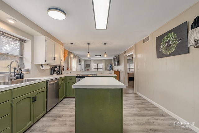 kitchen featuring kitchen peninsula, dishwasher, light hardwood / wood-style floors, and sink