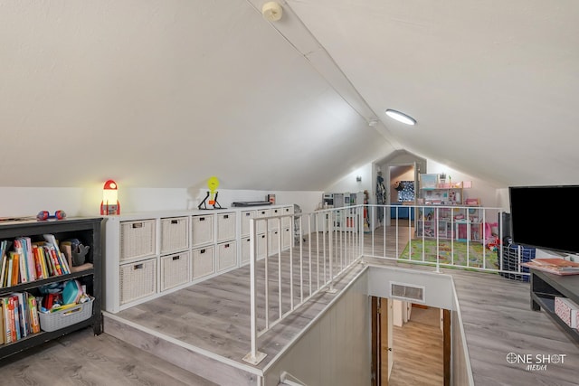 interior space featuring light hardwood / wood-style flooring and vaulted ceiling