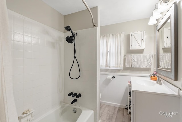 bathroom featuring vanity, wood-type flooring, and tiled shower / bath combo