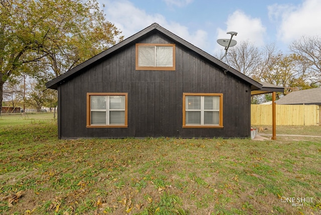 view of side of property with a lawn