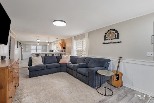 living room with plenty of natural light and light hardwood / wood-style floors