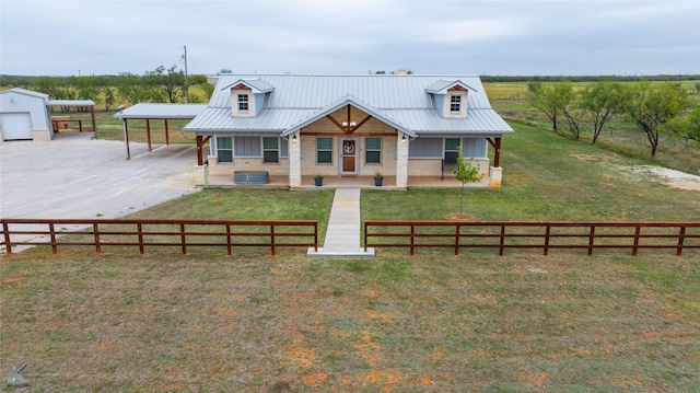 view of front of house with a porch, a front yard, and a rural view