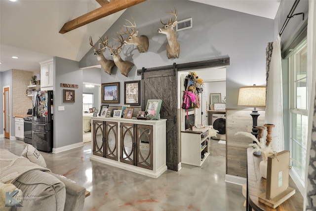 interior space with a barn door and washing machine and dryer