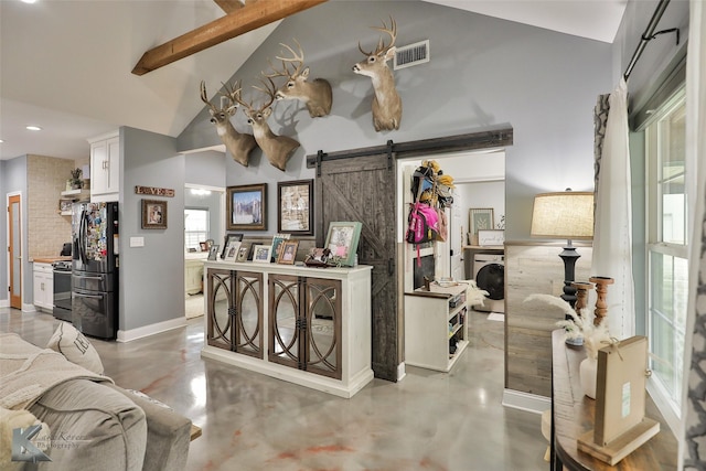 welcome area with washing machine and dryer and a barn door