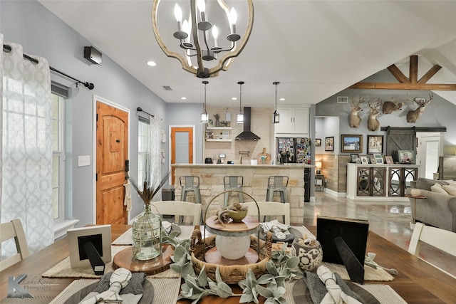 dining room with beamed ceiling, light wood-type flooring, a barn door, and a notable chandelier