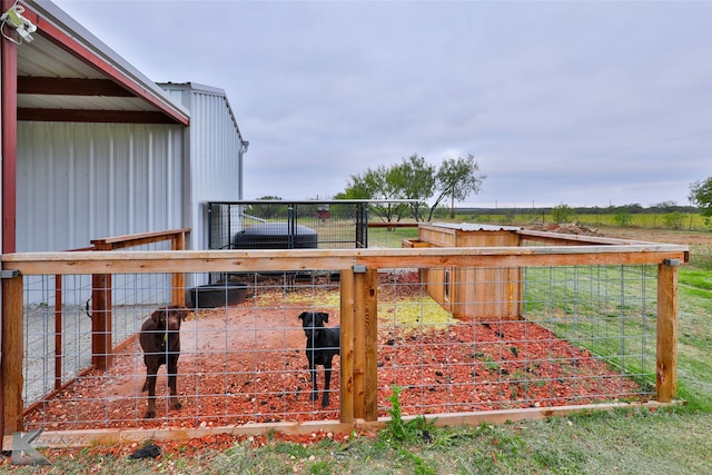 view of yard featuring a rural view and an outdoor structure