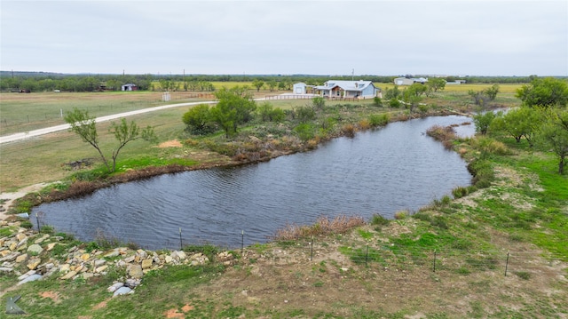 birds eye view of property featuring a water view and a rural view