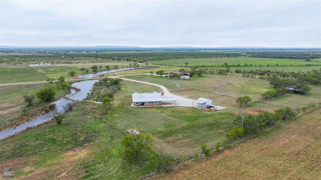 birds eye view of property with a water view and a rural view