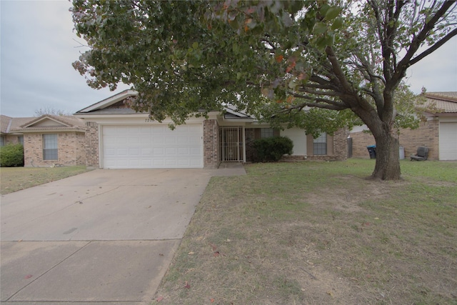 7208 Ridge Rd W, Fort Worth, TX 76133 - view of front of home featuring a garage, driveway, a front lawn, and brick siding