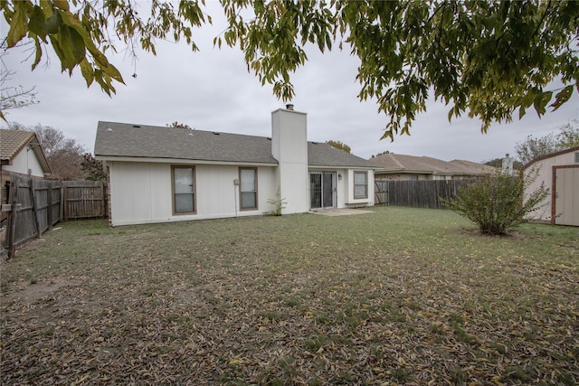 7208 Ridge Rd W, Fort Worth, TX 76133 - rear view of property featuring a fenced backyard, a chimney, and a storage shed