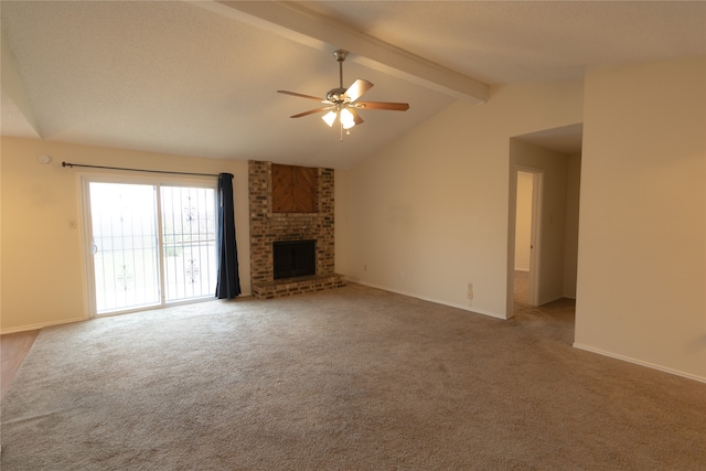 unfurnished living room featuring ceiling fan, carpet flooring, a fireplace, and vaulted ceiling with beams