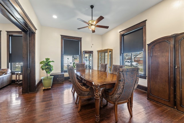 dining space featuring a ceiling fan, baseboards, and wood finished floors