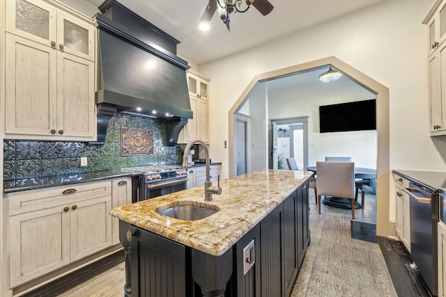 kitchen with premium range hood, decorative backsplash, stainless steel appliances, and wood finished floors