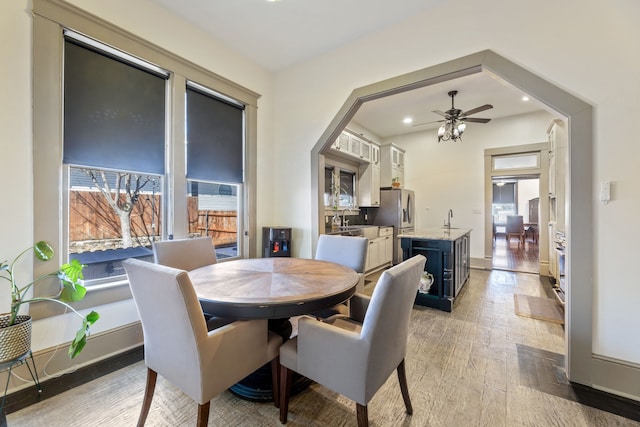 dining space with light wood finished floors, ceiling fan, baseboards, and recessed lighting