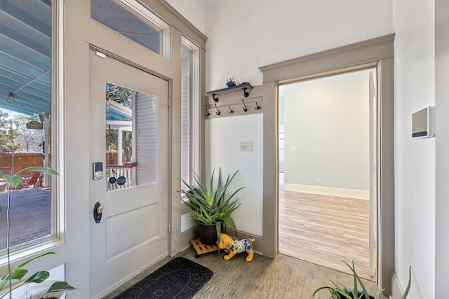 entryway with wood finished floors and baseboards