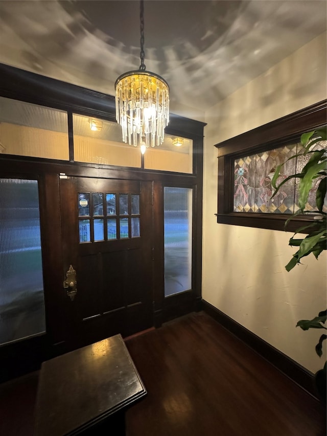 foyer featuring a notable chandelier and dark hardwood / wood-style floors