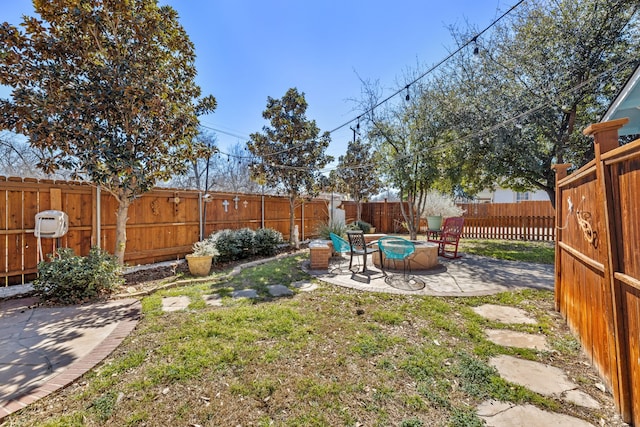 view of yard featuring an outdoor fire pit, a patio area, and a fenced backyard