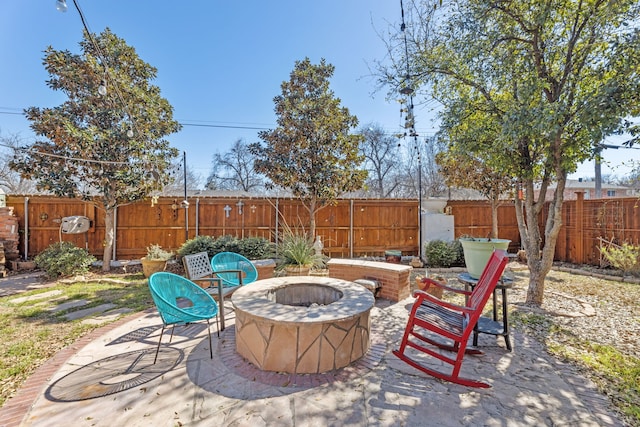 view of patio featuring an outdoor fire pit and a fenced backyard