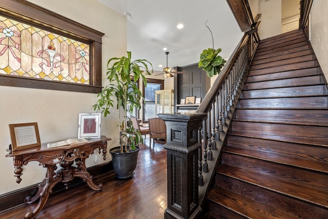 staircase featuring recessed lighting, ceiling fan, and wood finished floors