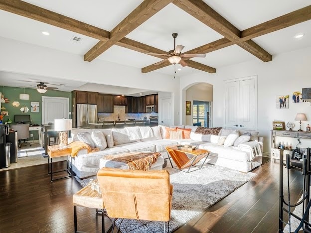 living room with coffered ceiling, dark wood-type flooring, ceiling fan, and beam ceiling