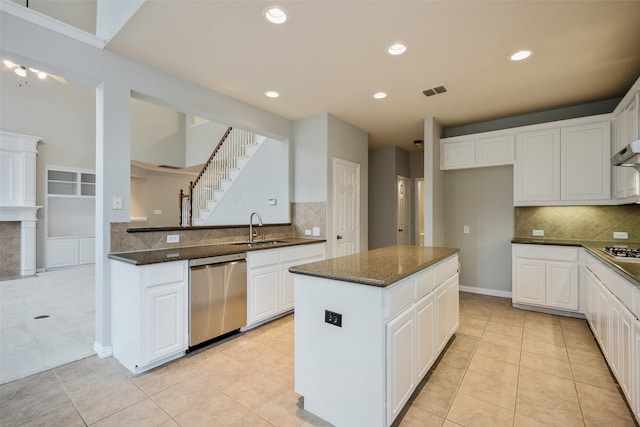 kitchen featuring dark stone countertops, white cabinetry, sink, and appliances with stainless steel finishes