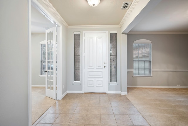 carpeted entryway featuring crown molding and a healthy amount of sunlight