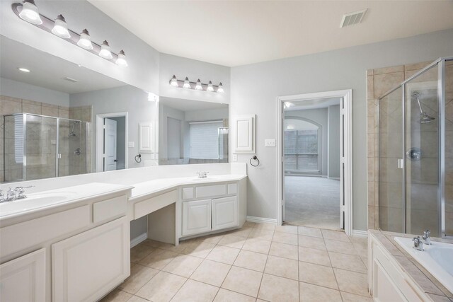 bathroom featuring tile patterned flooring, vanity, and separate shower and tub