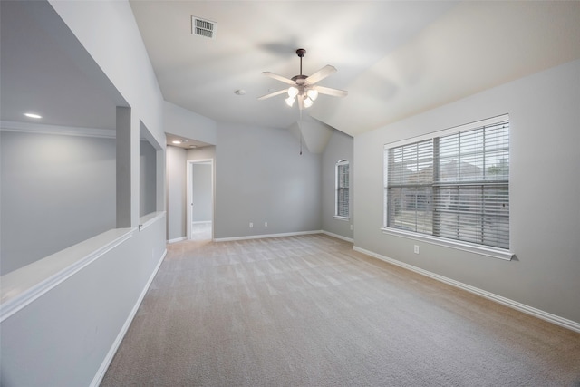 spare room featuring light colored carpet, ceiling fan, and lofted ceiling