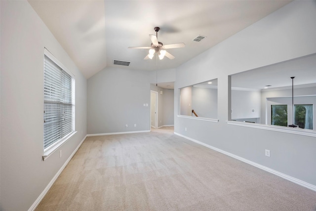 empty room with ceiling fan, light colored carpet, and lofted ceiling