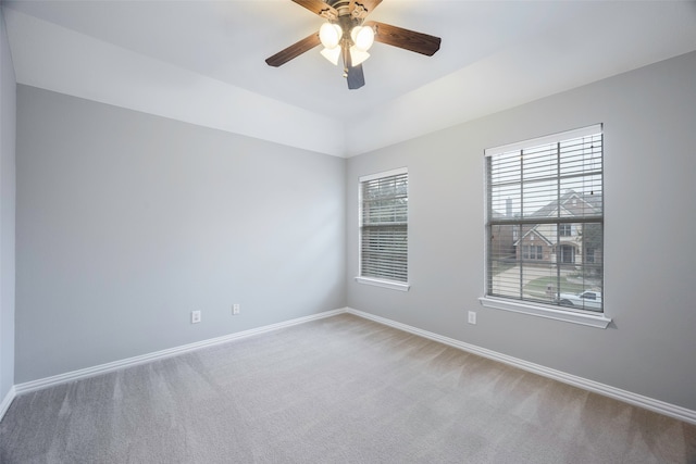 unfurnished room with ceiling fan and carpet