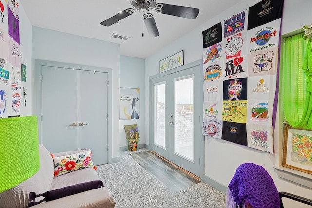 interior space featuring carpet flooring, ceiling fan, and french doors