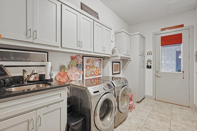 laundry room featuring cabinets, sink, and washing machine and clothes dryer