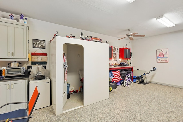 interior space with ceiling fan and white refrigerator