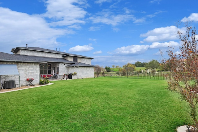 view of yard featuring central AC and a patio