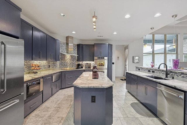 kitchen featuring a center island, sink, hanging light fixtures, wall chimney range hood, and black appliances