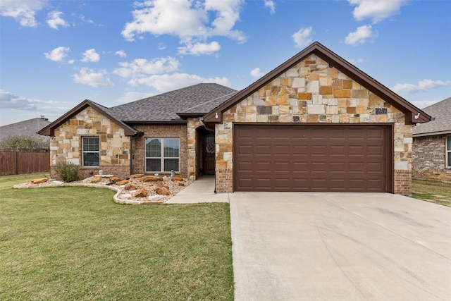 view of front of property featuring a garage and a front lawn