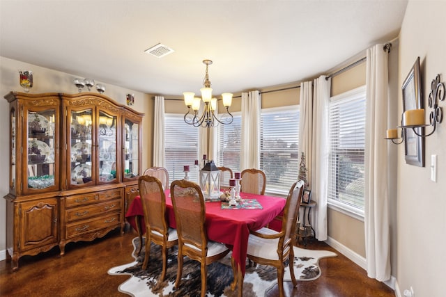 dining area featuring an inviting chandelier